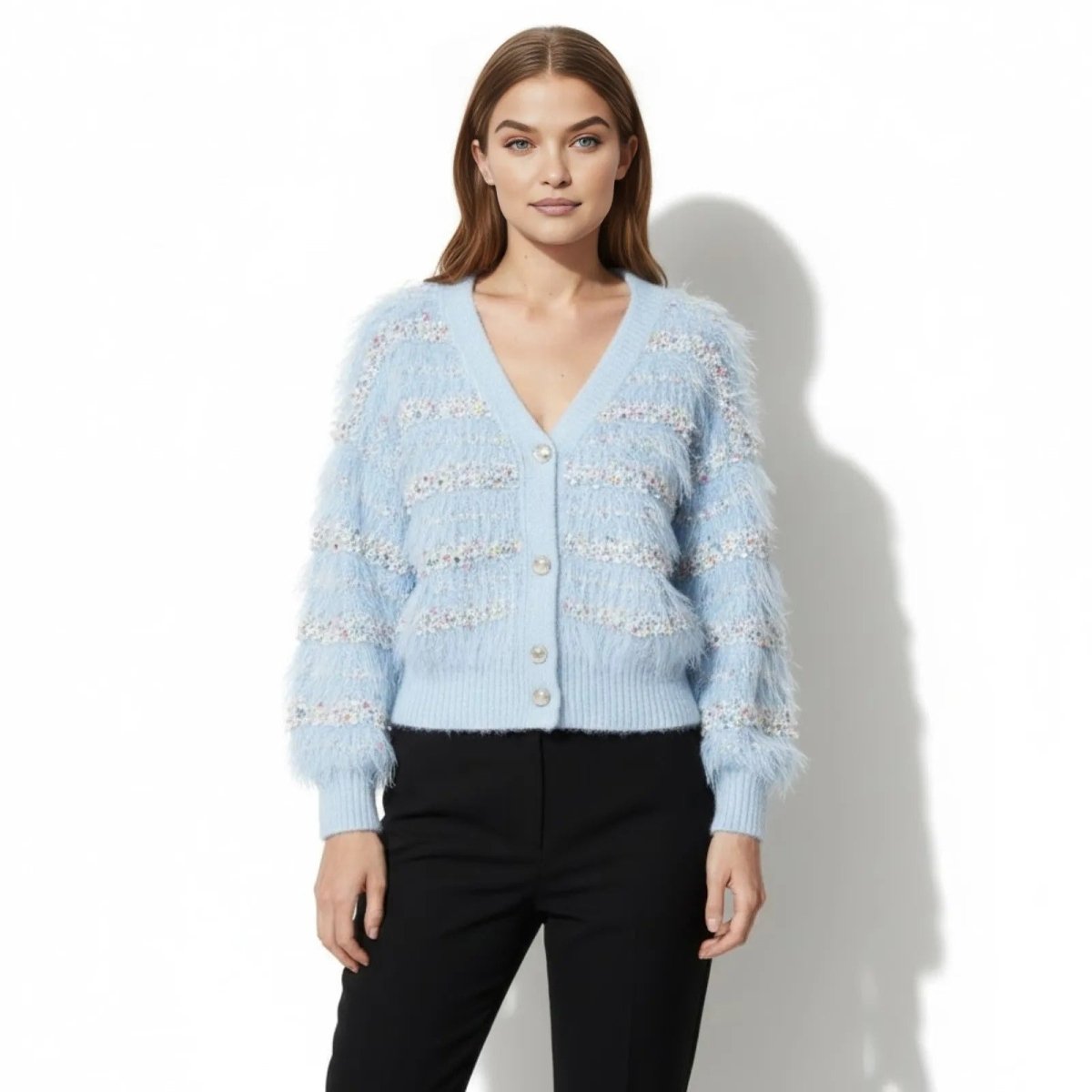 Model wearing the Kyra fuzzy light blue embellished cardigan from Kouvr Fashion, buttoned up and styled with black trousers.