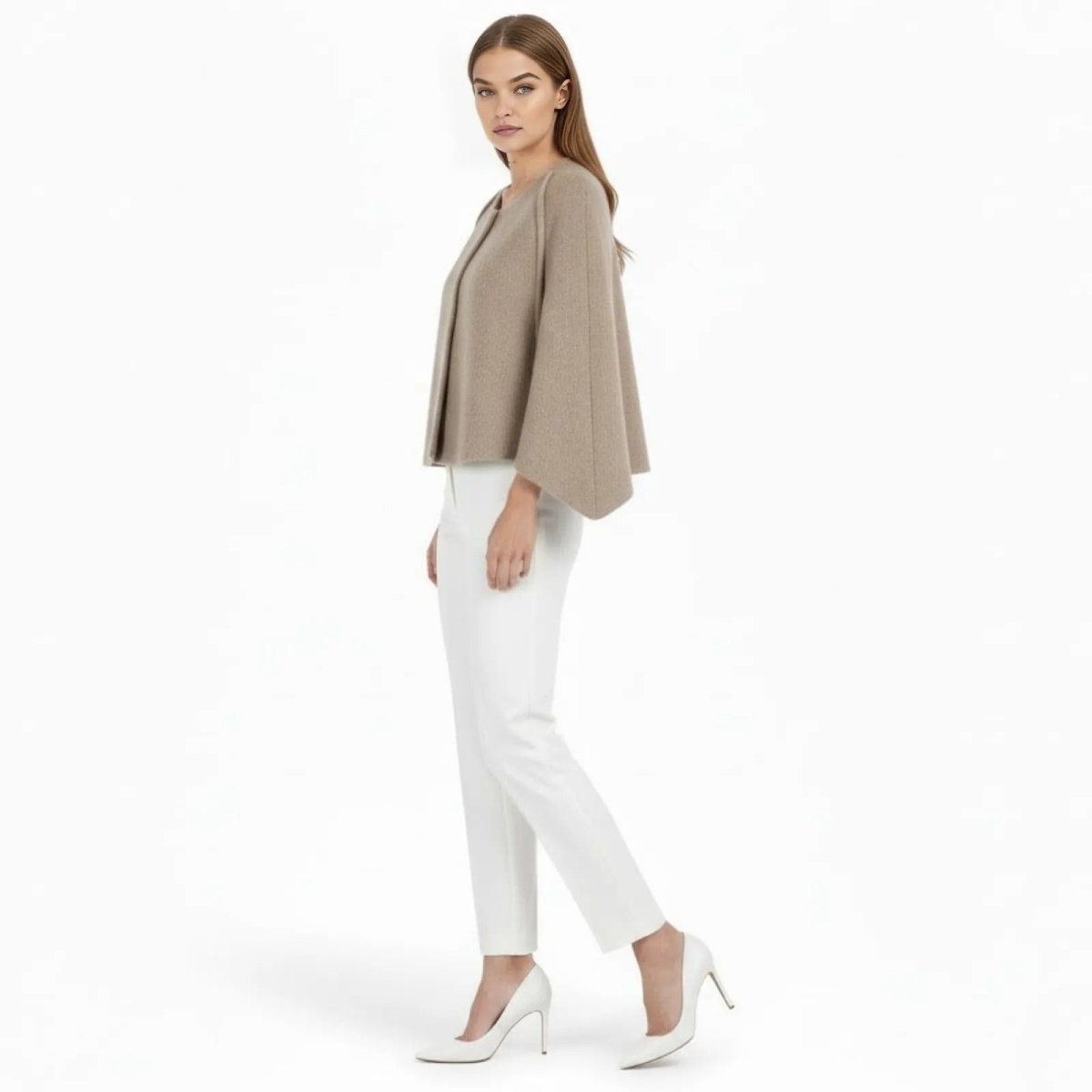 Side profile of the Laverne khaki wool cape jacket showing the sculptural bell sleeve silhouette and cropped length. 