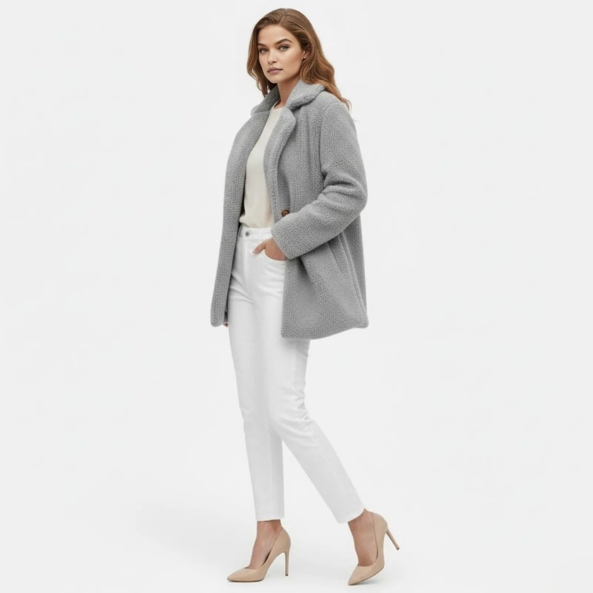 Model in a side profile view wearing the light grey sherpa jacket from Kouvr Fashion, showcasing its mid-length silhouette.