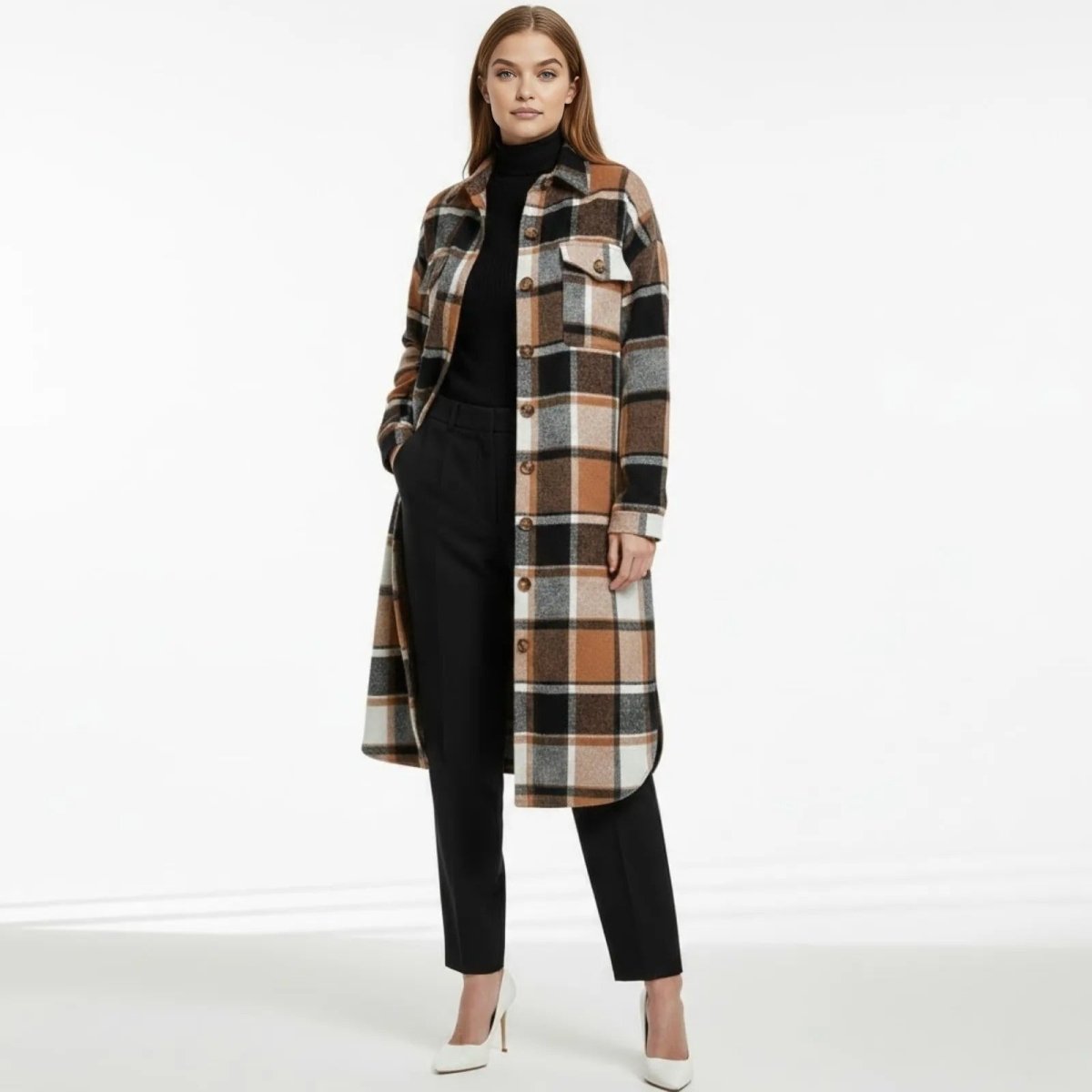 Model wearing a long khaki, black, and white plaid oversized shacket from Kouvr Fashion, styled with a black turtleneck, black trousers, and white heels.