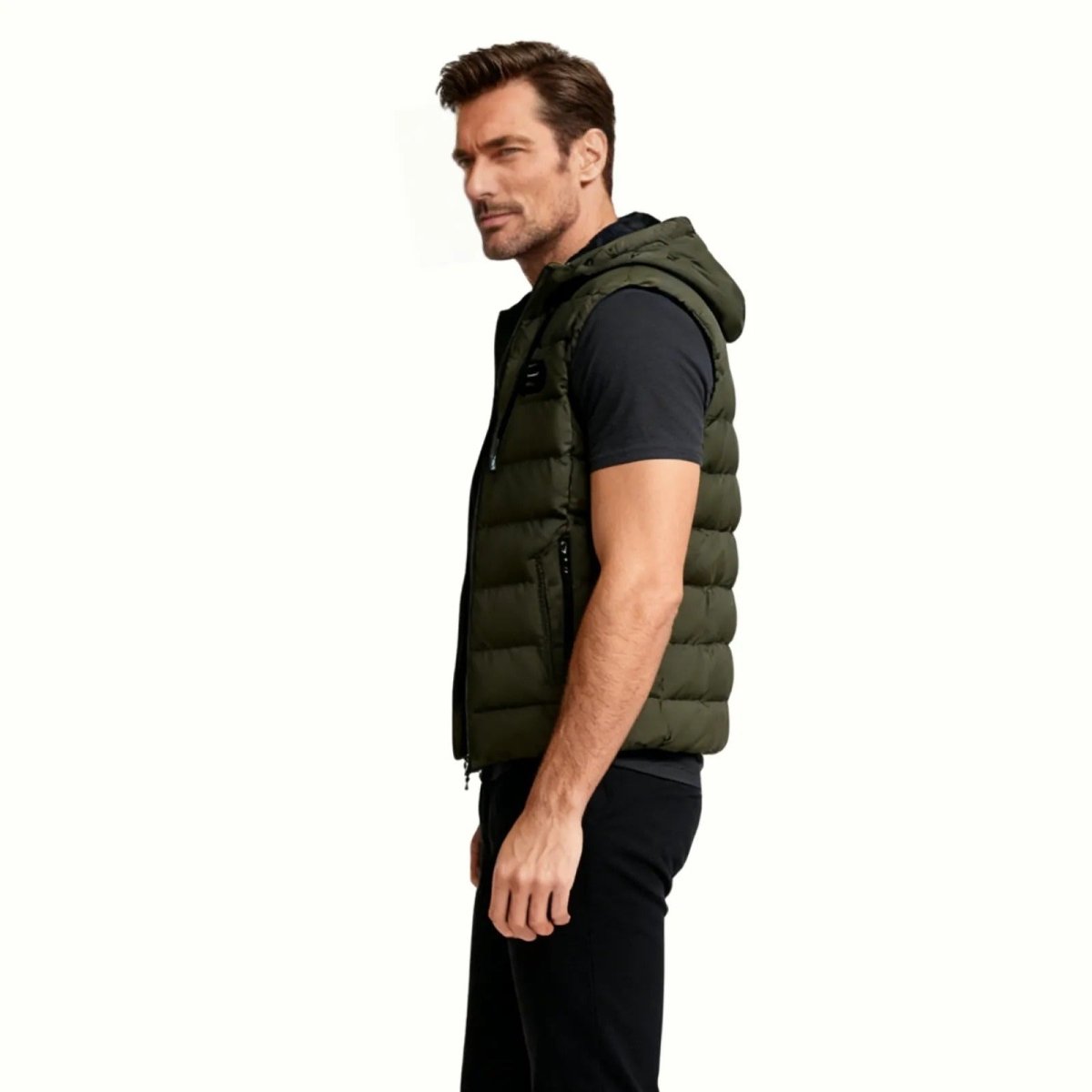 Side profile of a man in the Kouvr Fashion army green insulated vest showing its fit and silhouette. 