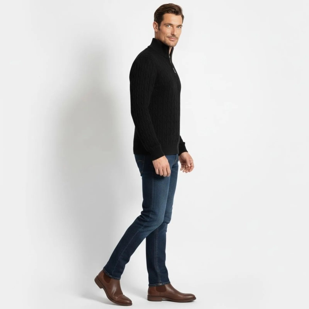 Side profile of a man walking while wearing the Kouvr Fashion black cable-knit half-zip sweater, showing the fit and sleeve detail.
