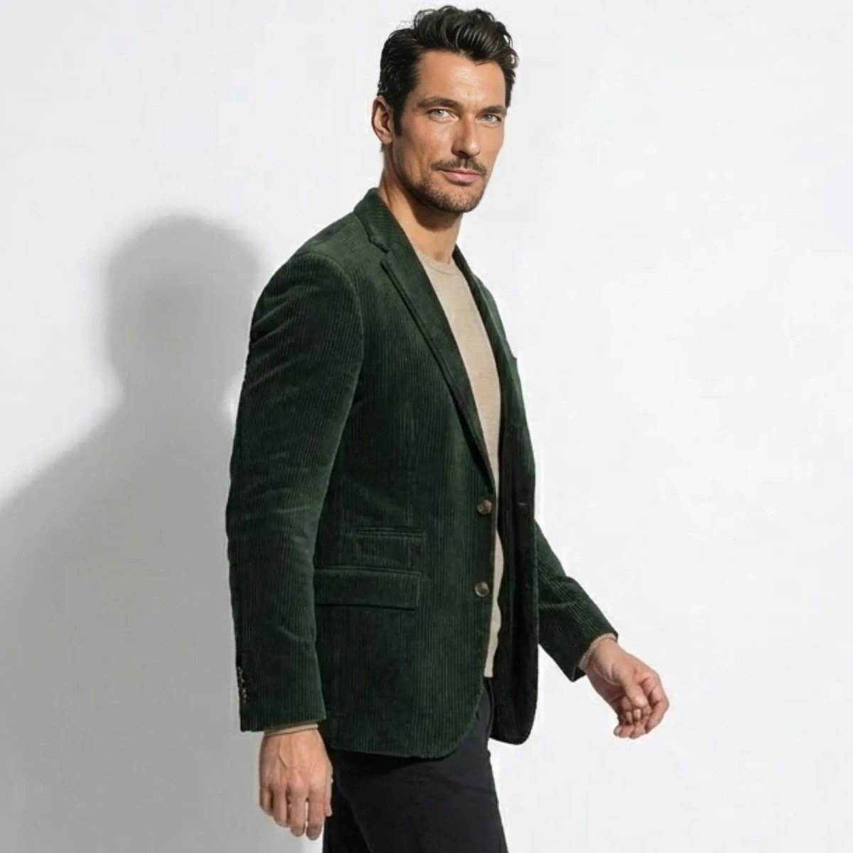 Side profile of a man in a Kouvr Fashion forest green grady sport coat, highlighting the jacket's structure and drape while in motion.