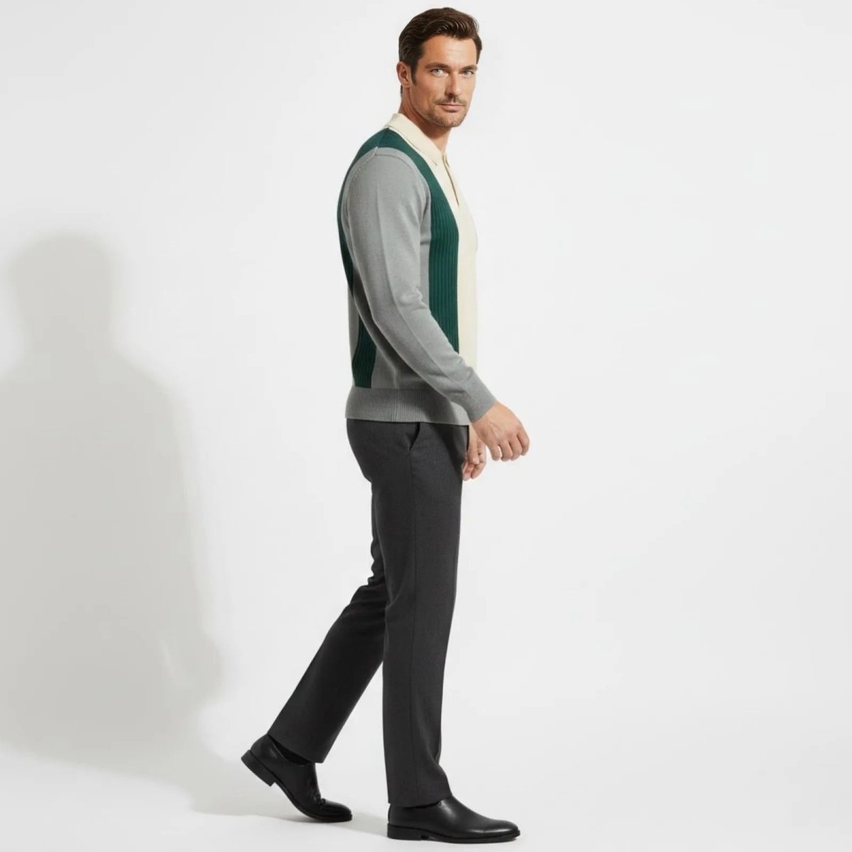 Side profile of a man walking in the Kouvr Fashion long sleeve vintage-style knit polo, showing the fit and sleeve design.
