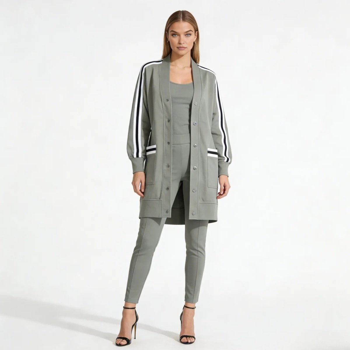 Model wearing the grey Nely Varsity Duster Jacket from Kouvr Fashion, paired with matching slim pants and heels, shown from the front.