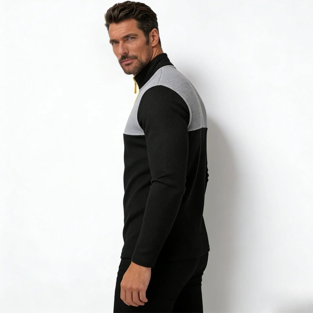 Side profile view of the men's slim fit Kouvr Fashion Ozzy color block pullover, highlighting the sweater's modern athletic silhouette.