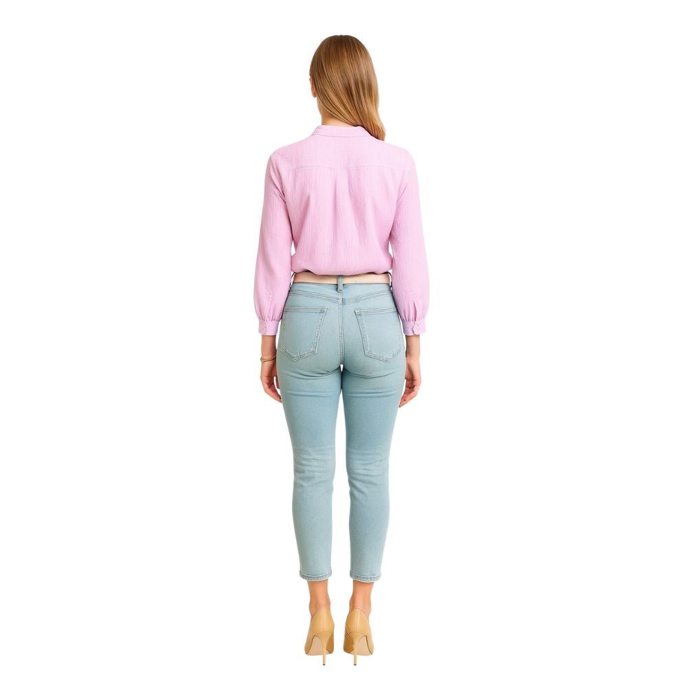 Model wearing the Kouvr Fashion Ruffle Neck Blouse, tucked into high-waisted light-wash jeans