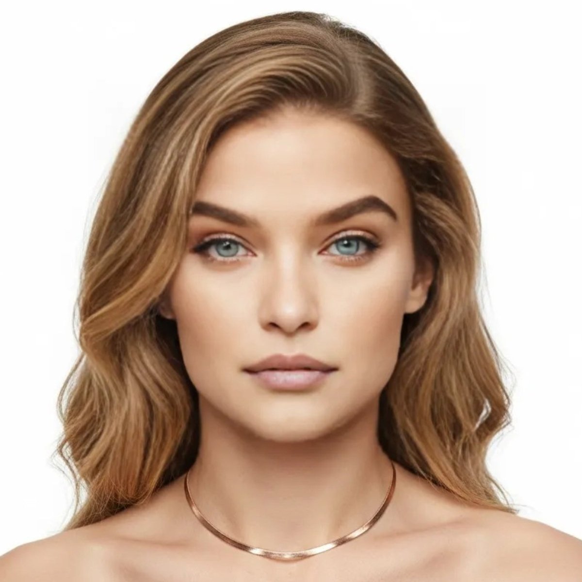 A woman with blonde hair and blue eyes wearing the Kouvr Fashion Amelia Rose Gold Snake Chain Necklace to showcase its length and shine.