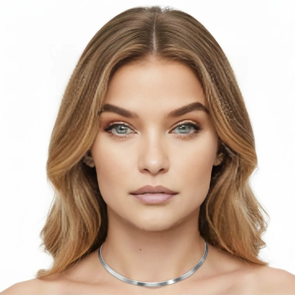 A woman with blonde hair and blue eyes wearing the Kouvr Fashion Amelia Silver Snake Chain Necklace to showcase its length and shine.