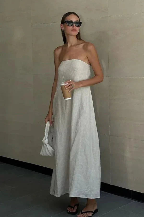 Model from behind wearing the Kouvr Fashion strapless linen maxi dress showing the smocked back detail