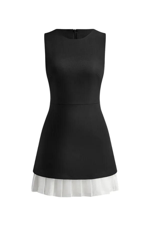 Model wearing the Kouvr Tessa black and white sleeveless A-line dress with pleated hem