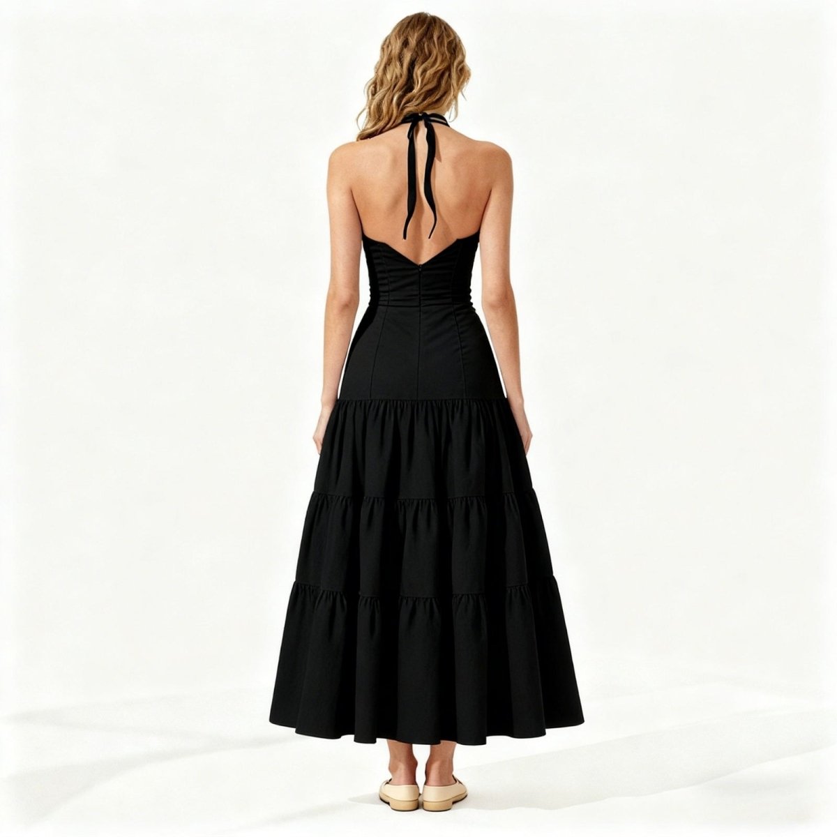 Woman wearing a black halter neck dress on a white background