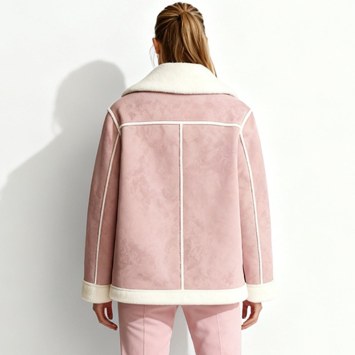 Back view of the Kouvr Fashion pink esmeralda jacket, highlighting the clean seam lines and wide sherpa collar.
