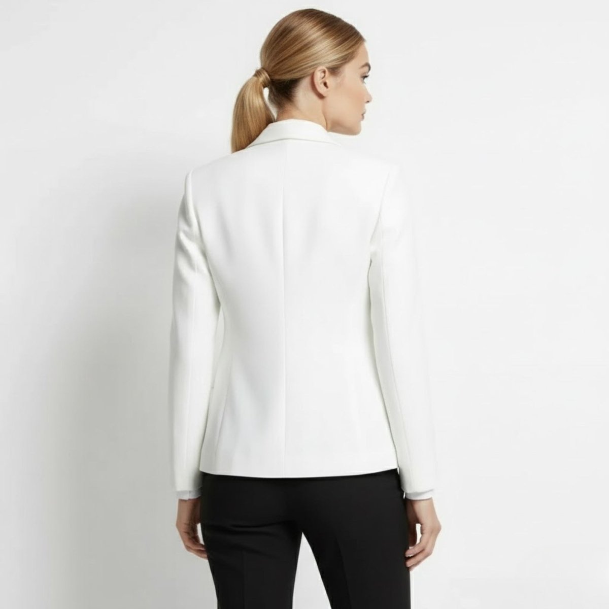 Back view of the Kouvr Fashion white blazer, highlighting the princess seam details for a flattering shape.