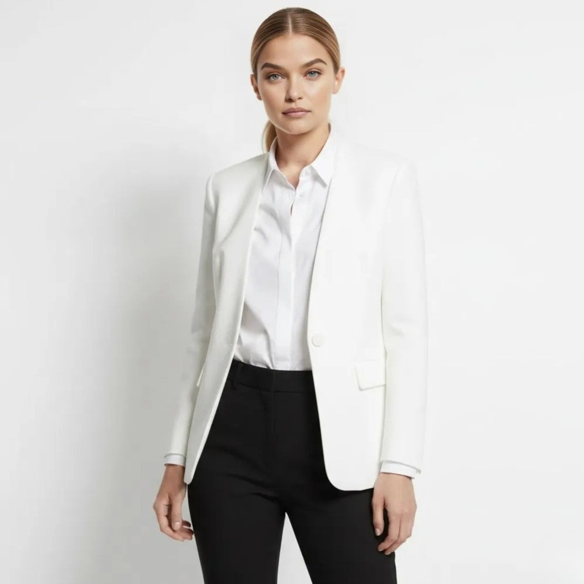 Model wearing the Kouvr Fashion tailored single-button white blazer with black trousers, styled for a professional look.