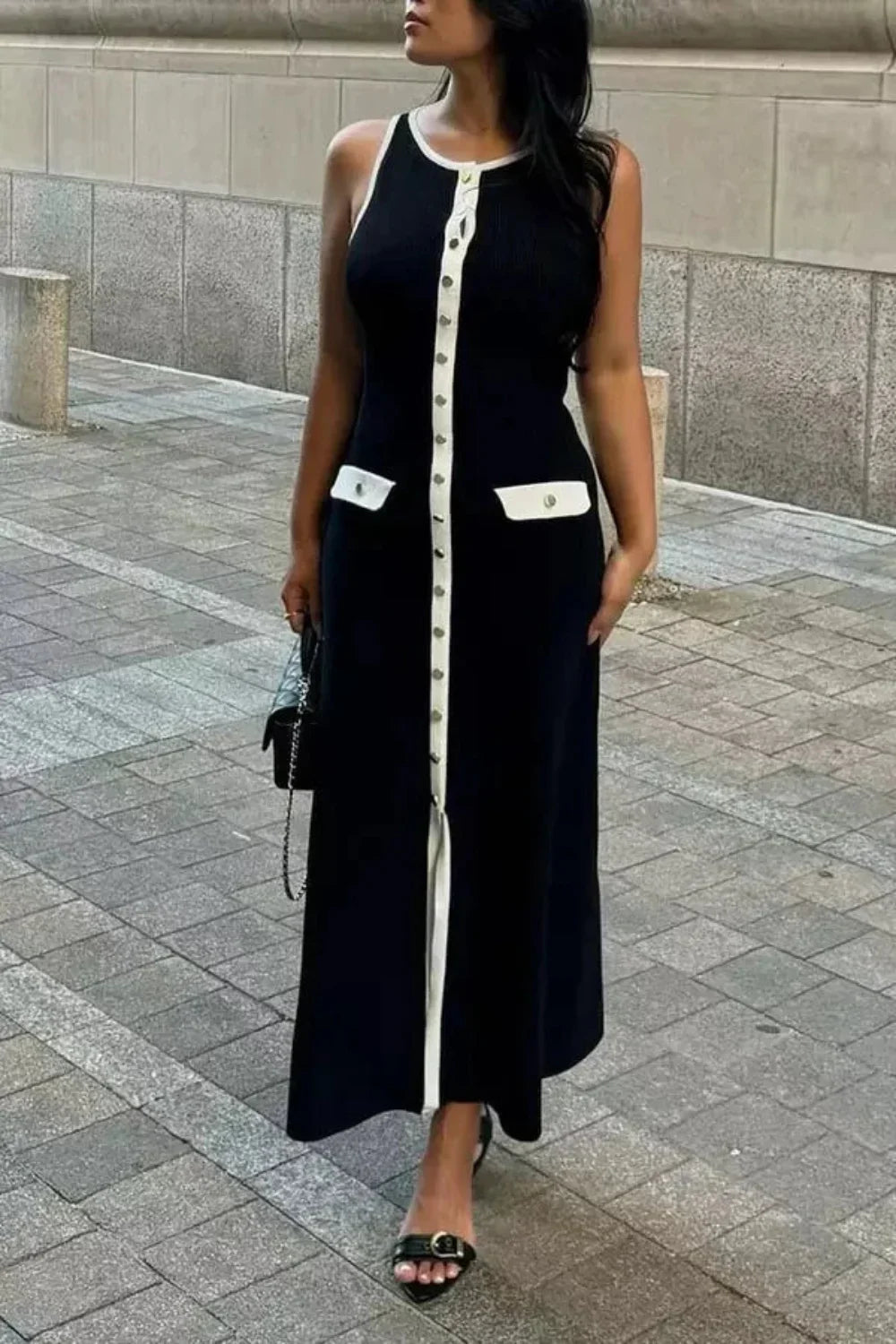 Kouvr Fashion Fiorella Knit Midi Dress in black worn by a model on a city street