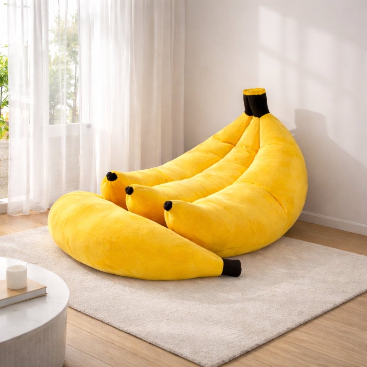 Large yellow banana shaped bean bag chair made of plush velvet with black tipped stem and supportive backrest for adults. 