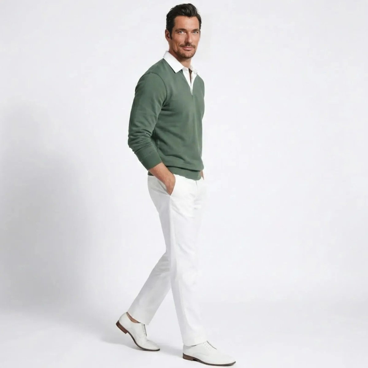 Side profile of a man walking in the Kouvr green long-sleeve knit polo, showcasing its tailored fit.