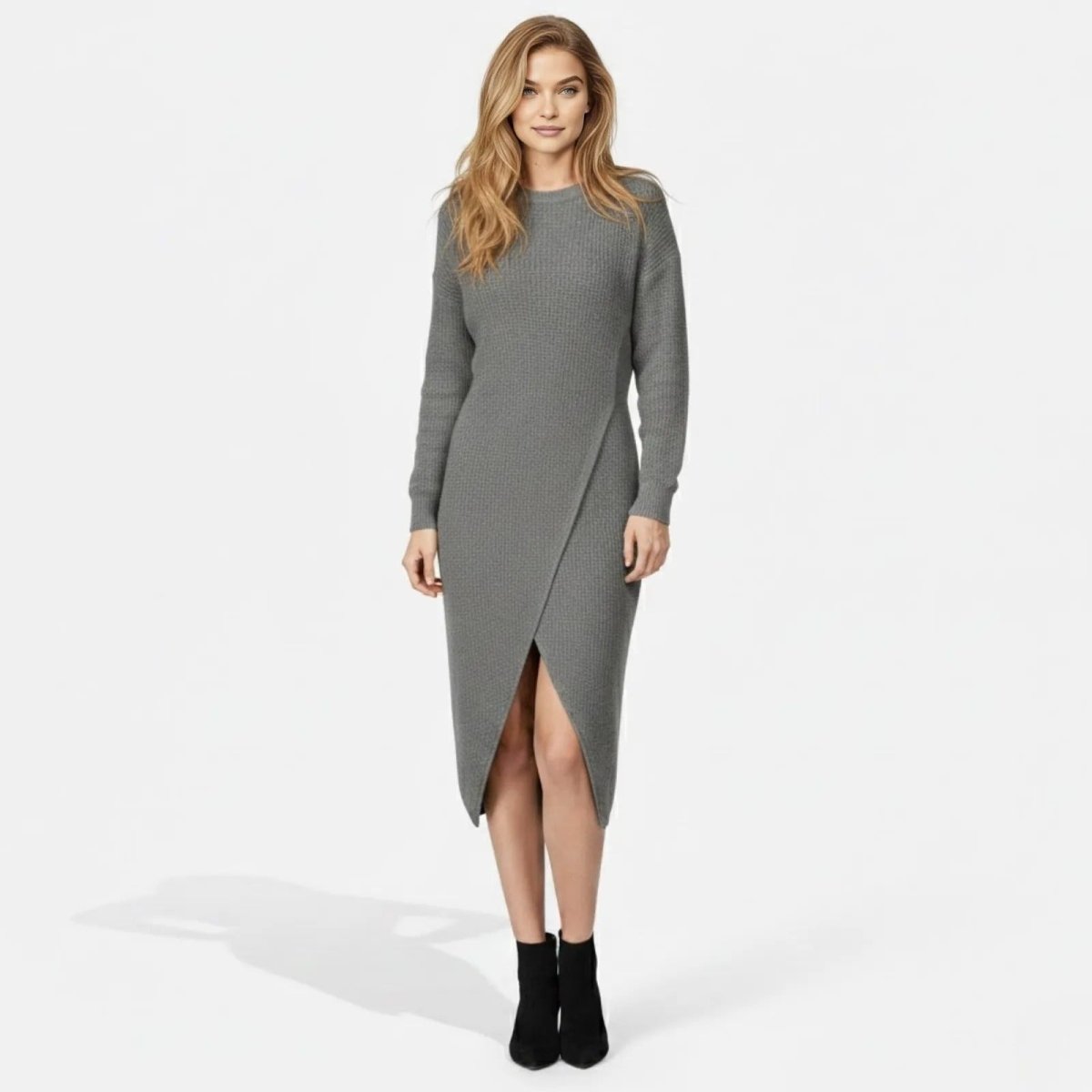 Model wearing the Janessa grey wrap knit sweater dress from Kouvr Fashion, showing the front view with the asymmetrical slit.