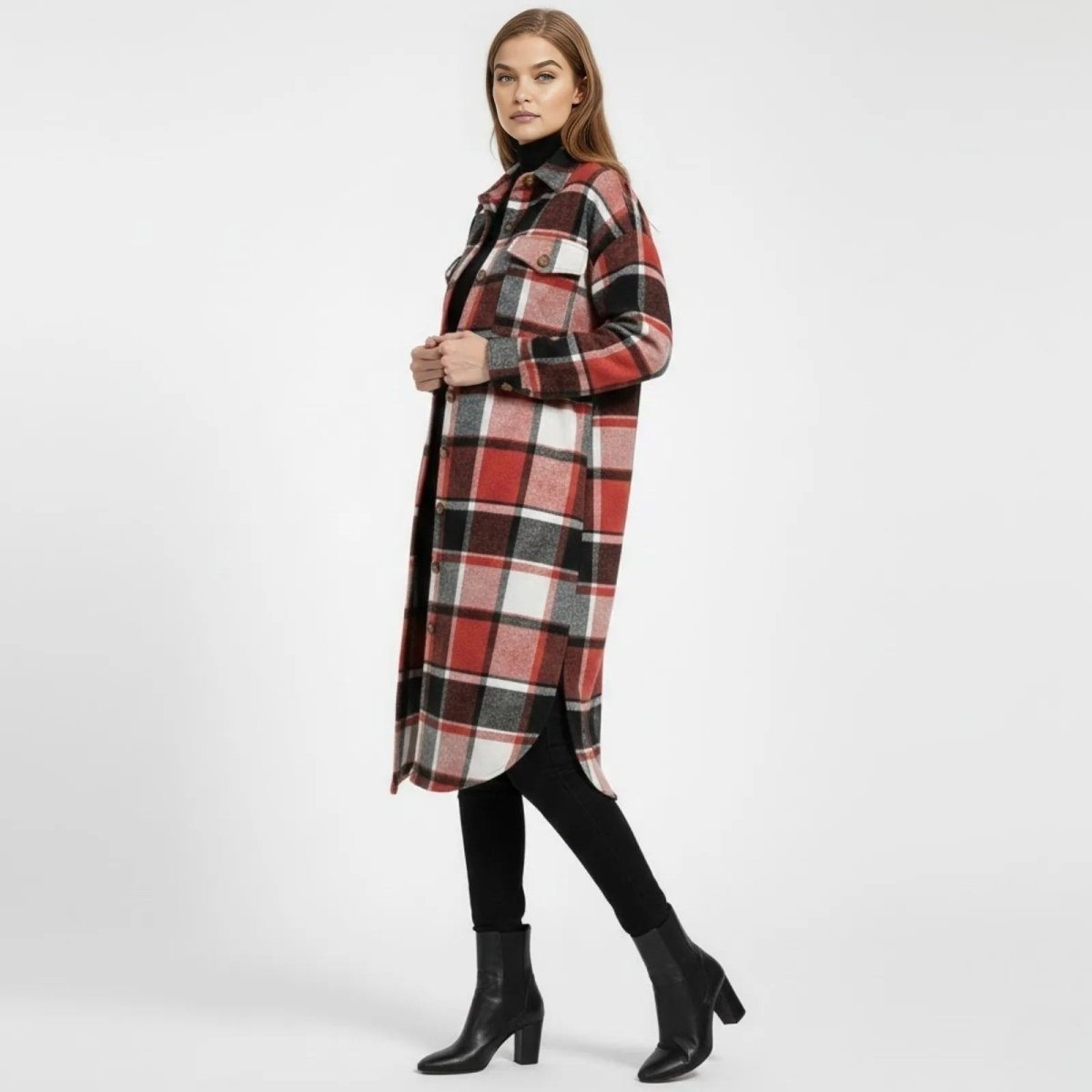 Model in a side profile view showcasing the length and drape of the red and black Janet maxi plaid shacket, highlighting the side slit and relaxed fit.