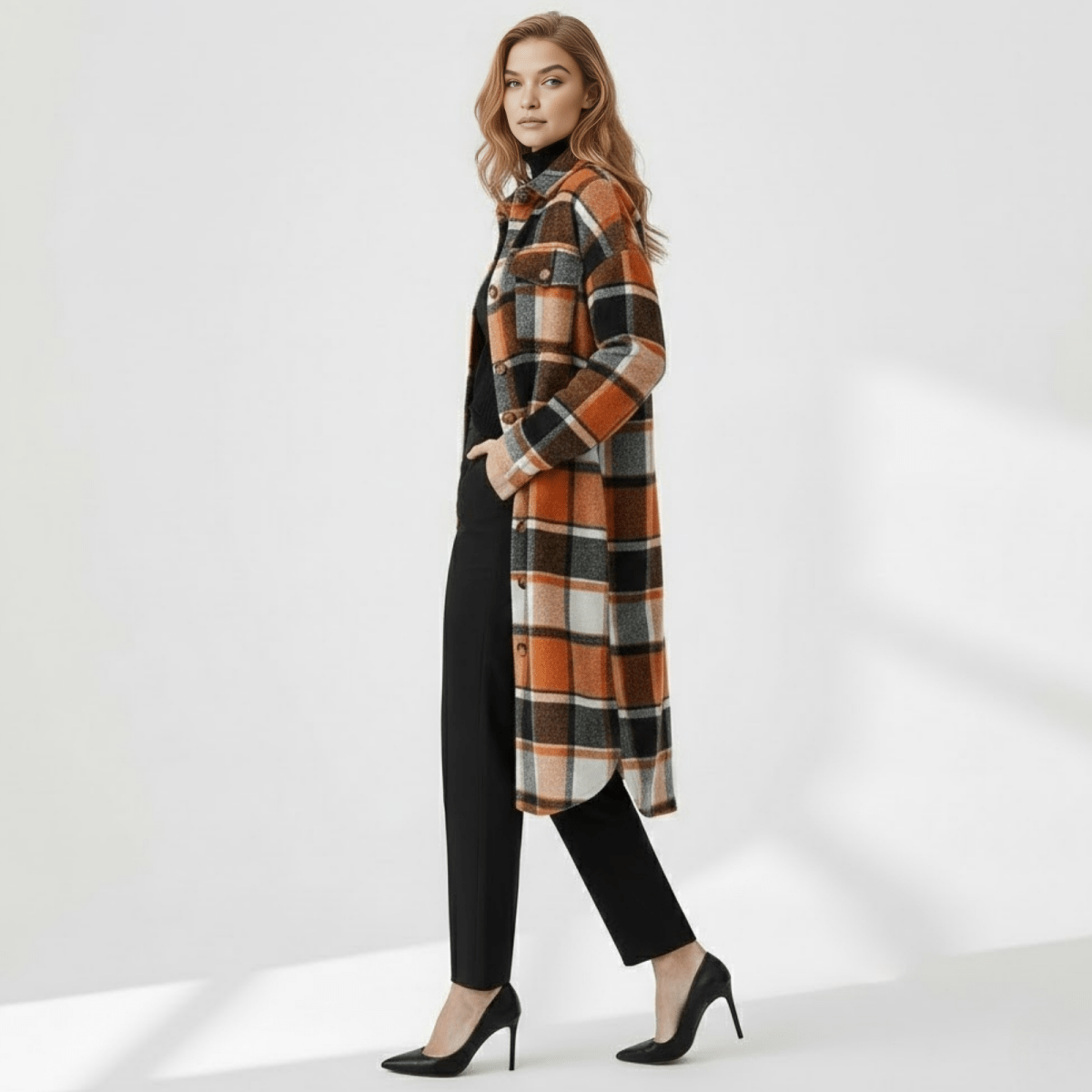 Side profile of a woman walking in the Kouvr Janet Longline Plaid Shacket, showing the curved hem and oversized fit.