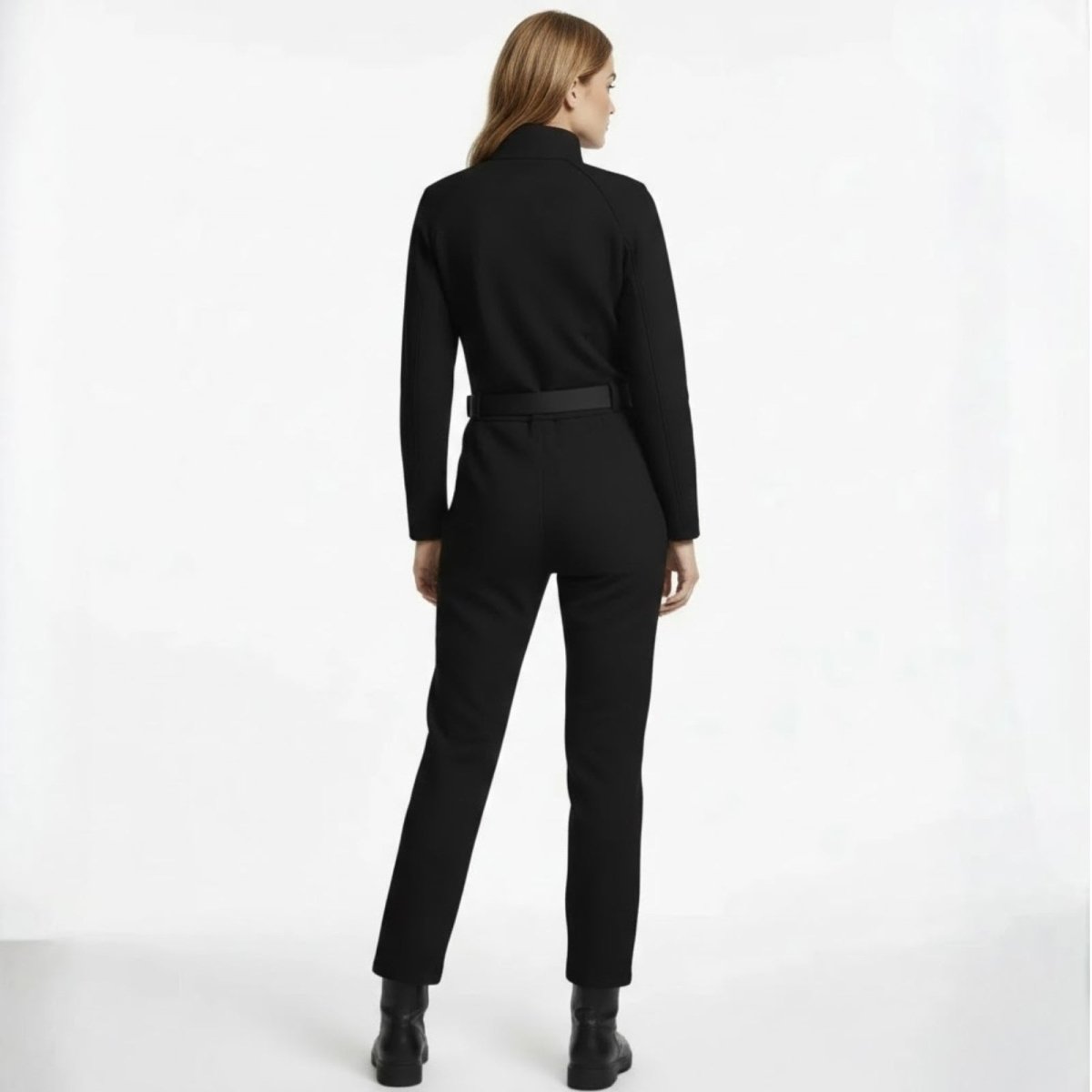 Back view of the Kouvr Junnie black jumpsuit highlighting the belt detail and raglan sleeve construction. 