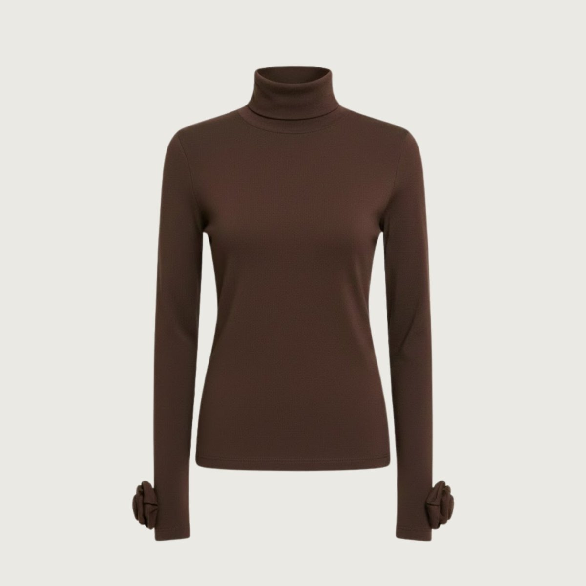 Product shot of the Kouvr Fashion brown turtleneck top laid flat, showing the full length and rosette cuffs.
