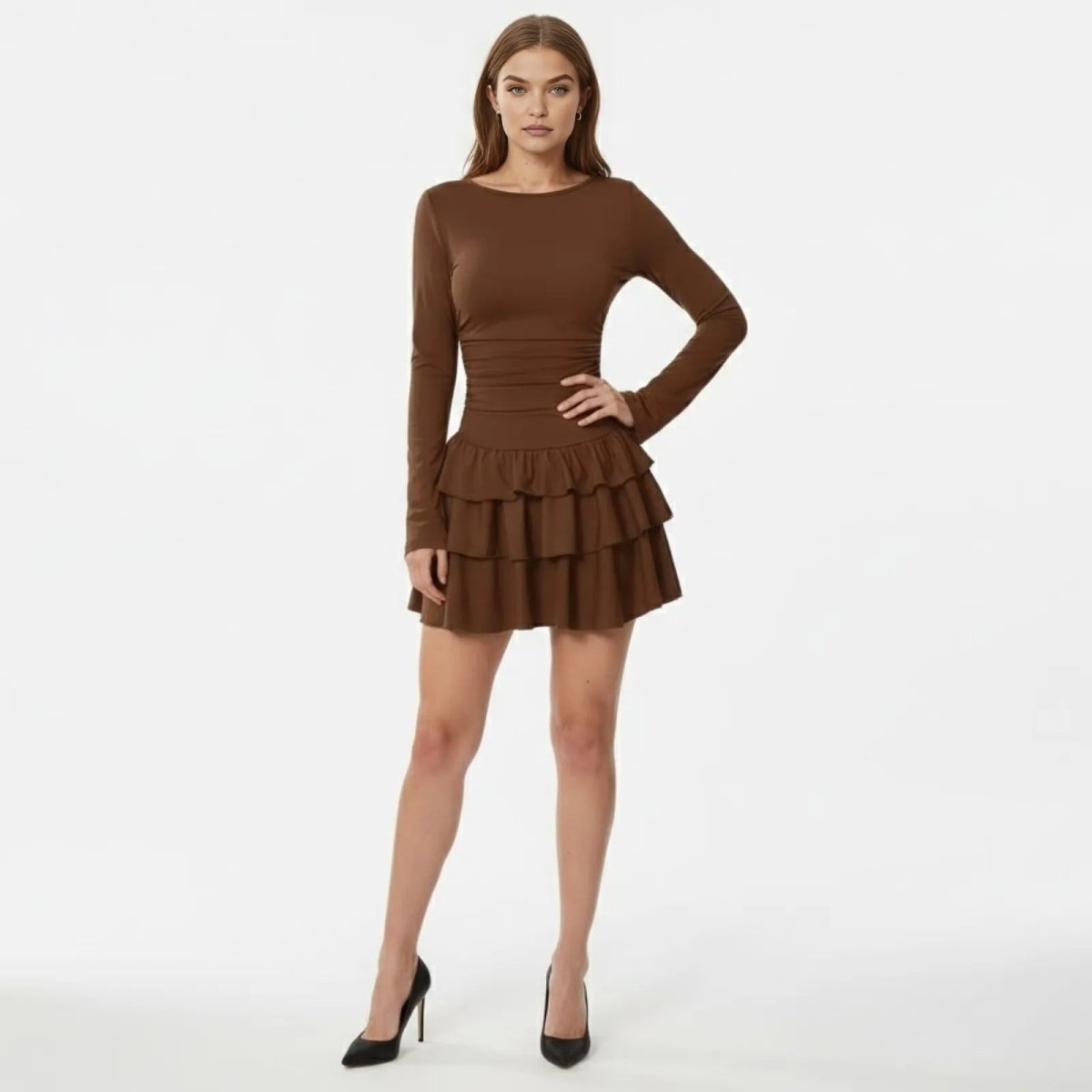 Model wearing the Leona brown long sleeve ruffle mini dress by Kouvr, front view.