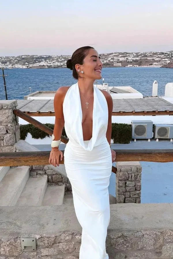 Model wearing the white satin backless Meliora Gown by Kouvr Fashion