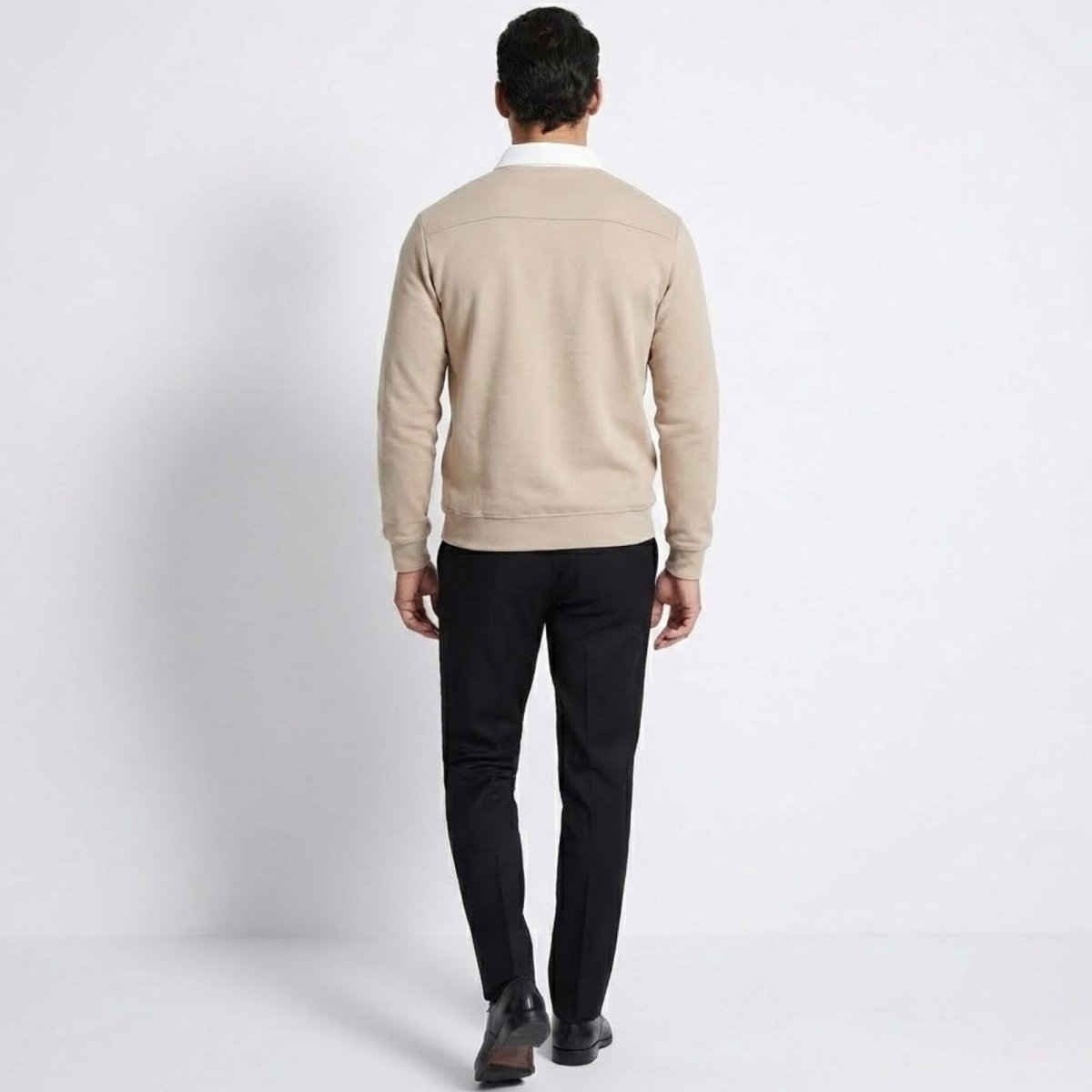 Back view of the Kouvr men's light beige polo sweater, showing the yoke detail and fit across the shoulders.