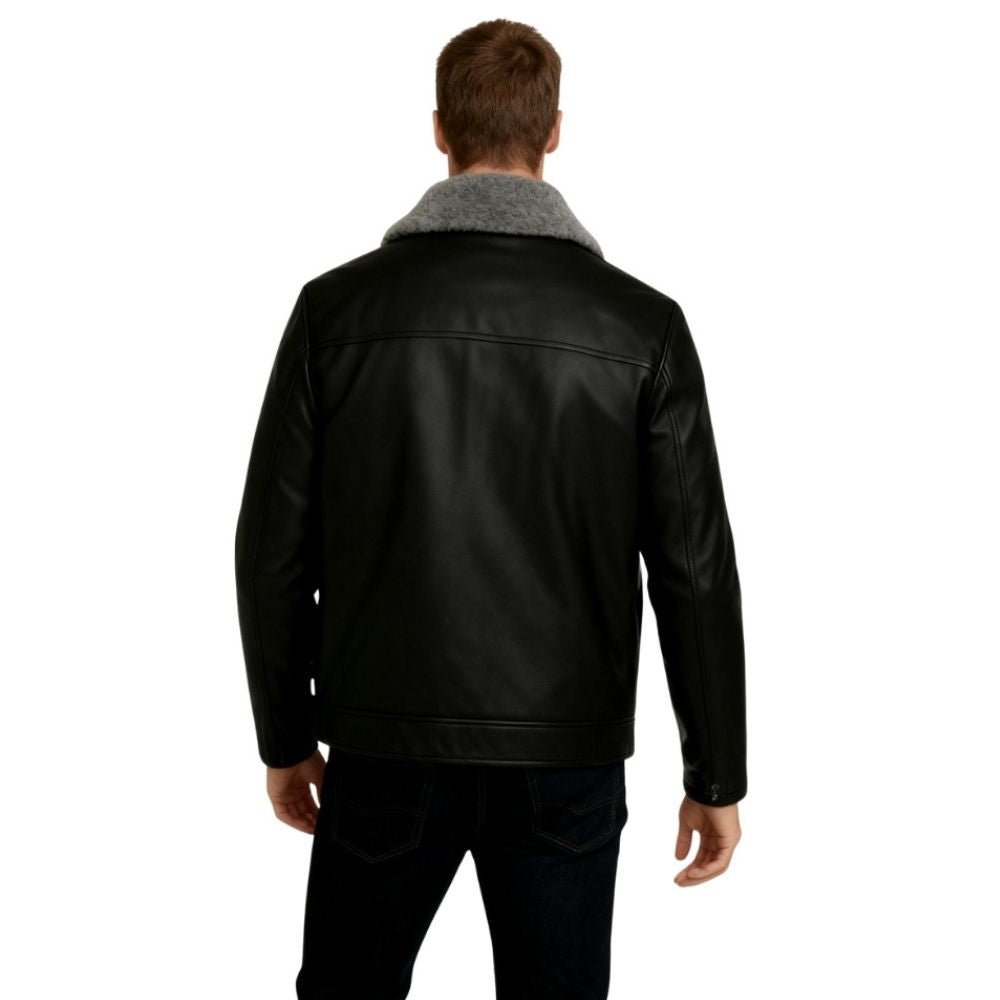 Man wearing a black kouvr leather jacket with gray fur collar on a white background