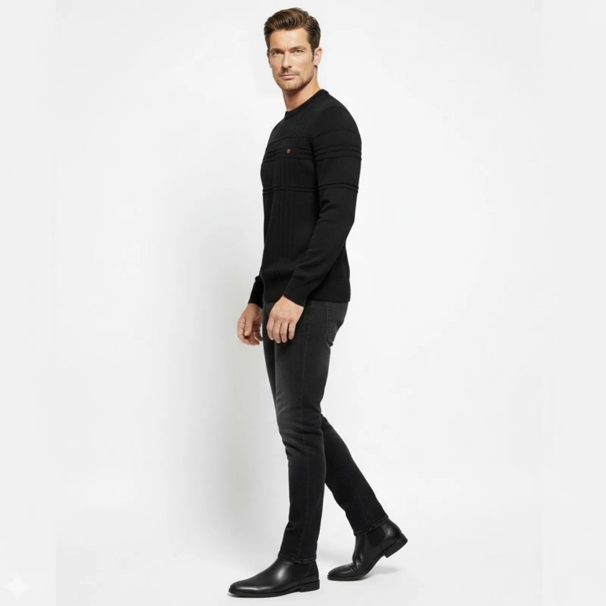 Side profile of a man wearing the Kouvr slim fit black textured sweater showing the ribbed sleeve detail.
