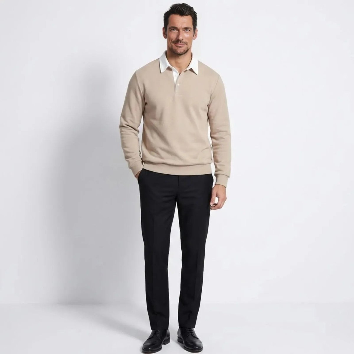Man wearing the Kouvr light beige long sleeve knitted polo sweater with black trousers, showing the classic fit.