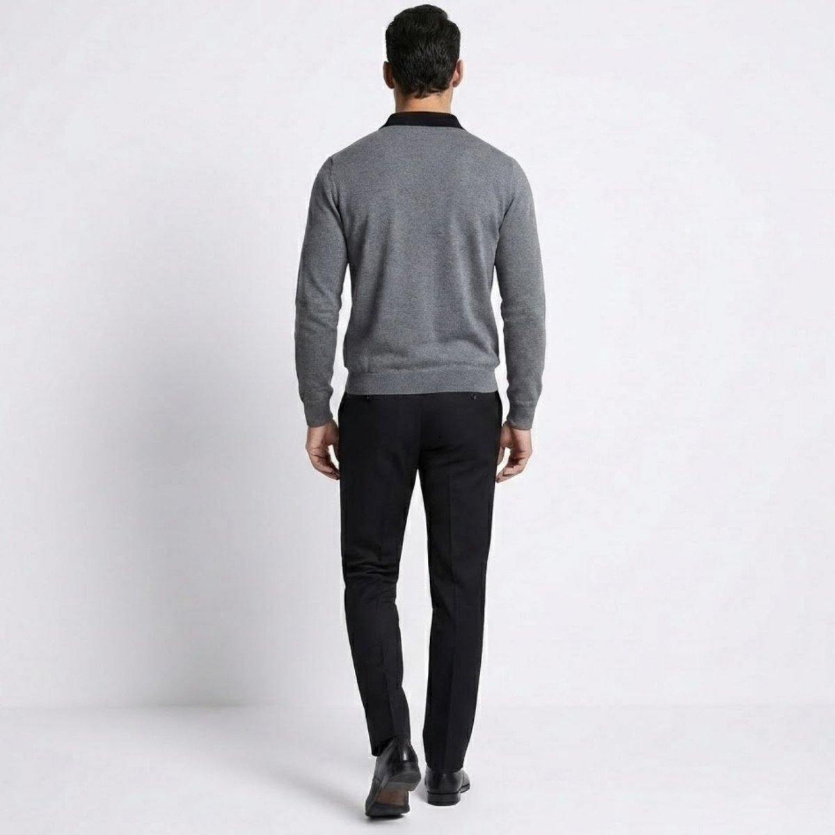 Back view of the Kouvr men's heather dark grey merino wool polo sweater demonstrating the clean drape and fit.