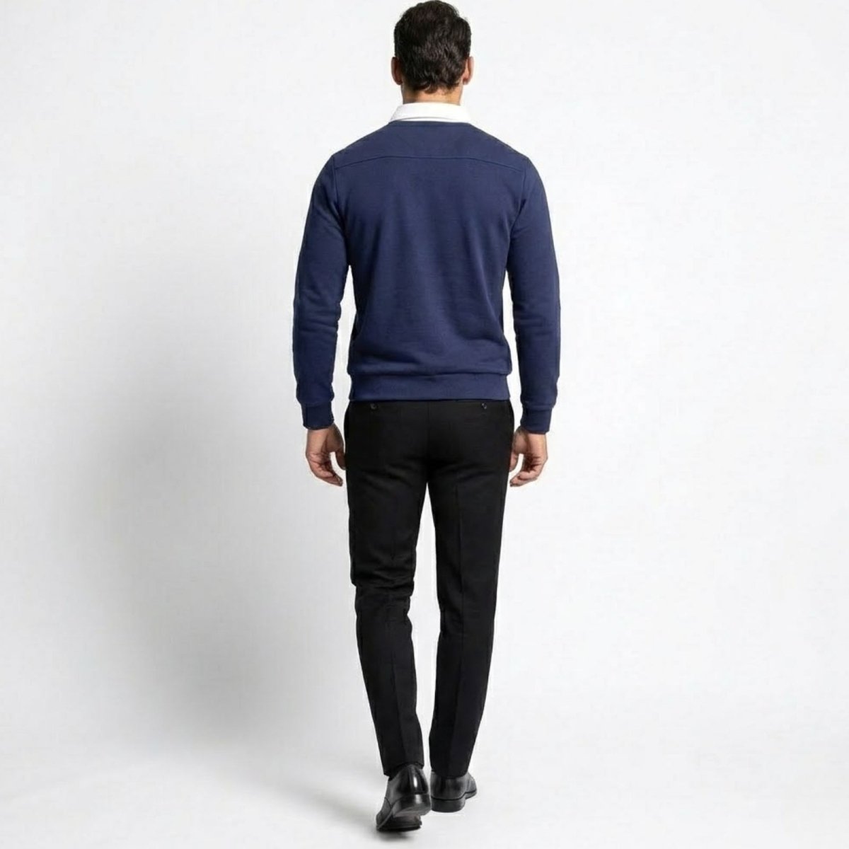 Back view of the Kouvr men's navy blue knit polo, highlighting the clean lines and tailored fit from behind.