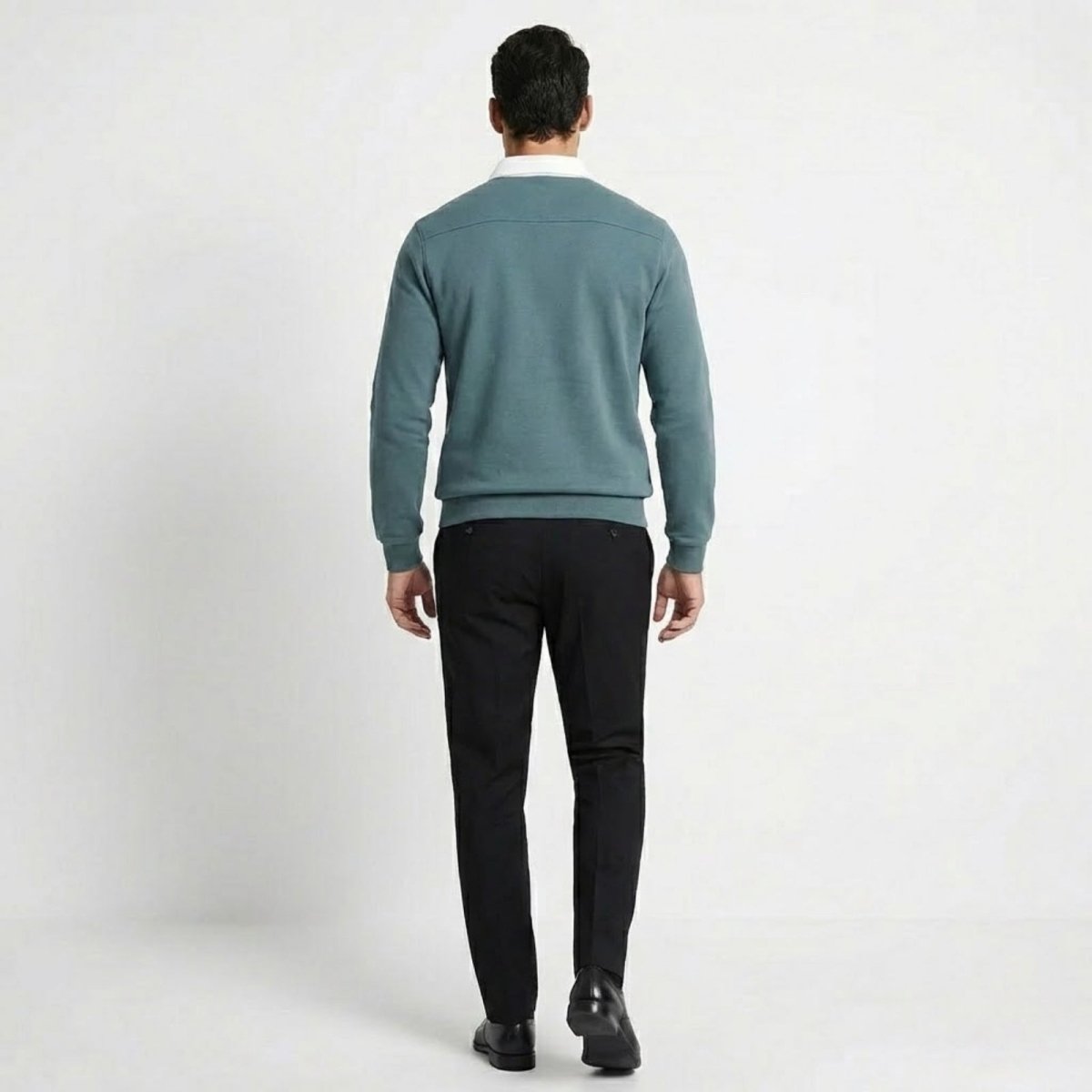 Back view of Kouvr's grey blue polo sweatshirt worn by a model, highlighting the shoulder seam detail. 