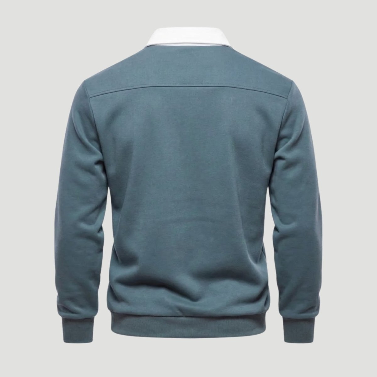  Flatlay studio shot of the back of a men's grey blue long-sleeve polo, showing the clean construction and shoulder yoke seam.