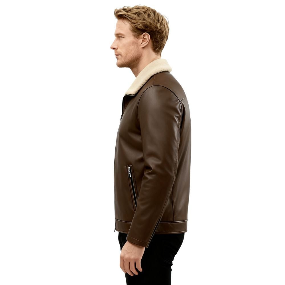 Man wearing a dark brown kouvr leather jacket with white fur lining on a white background