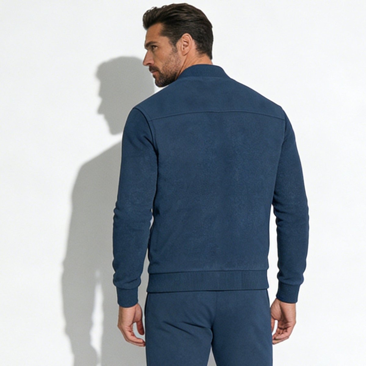 Back view of the Kouvr Michael suede bomber jacket in slate blue, detailing the precision shoulder yoke paneling.