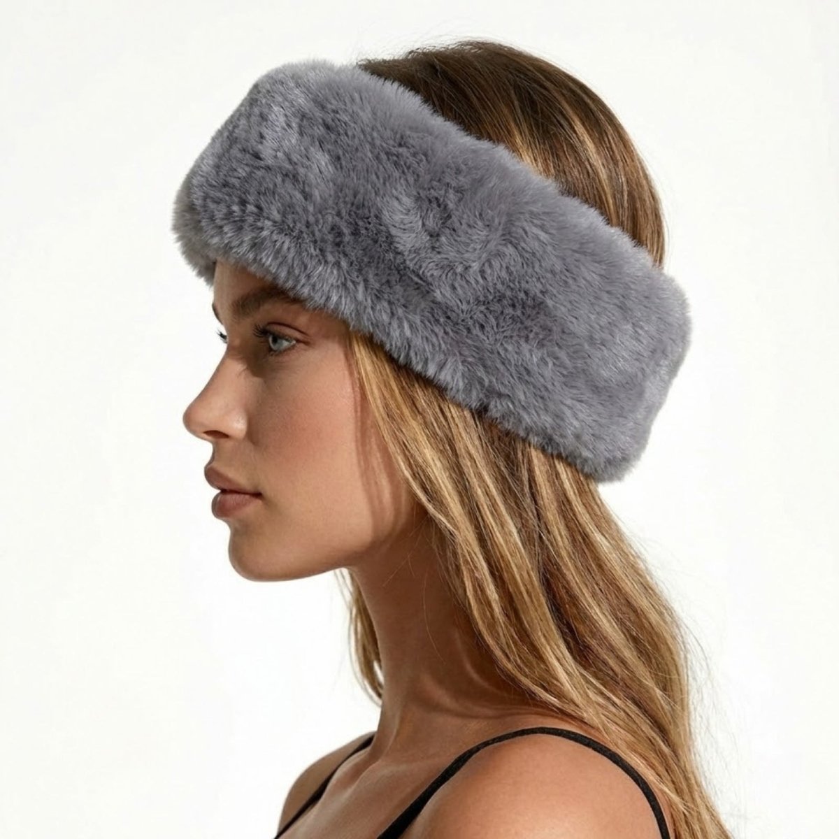 Side profile of a model wearing the Kouvr Nancie plush grey faux fur winter headband.