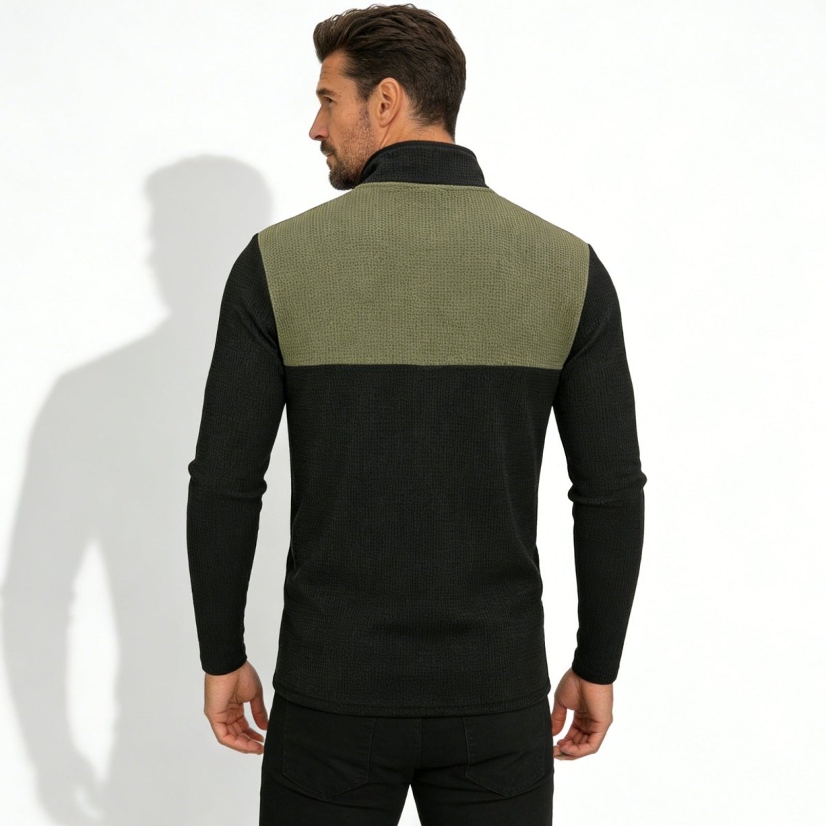 Back view of the Kouvr Ozzy men's pullover, displaying the olive green waffle knit upper panel and black ribbed lower section.