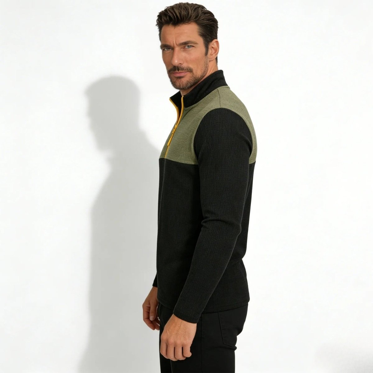 Side profile of a man wearing the Kouvr Ozzy color block mock neck sweater, highlighting the slim fit and two-tone design.