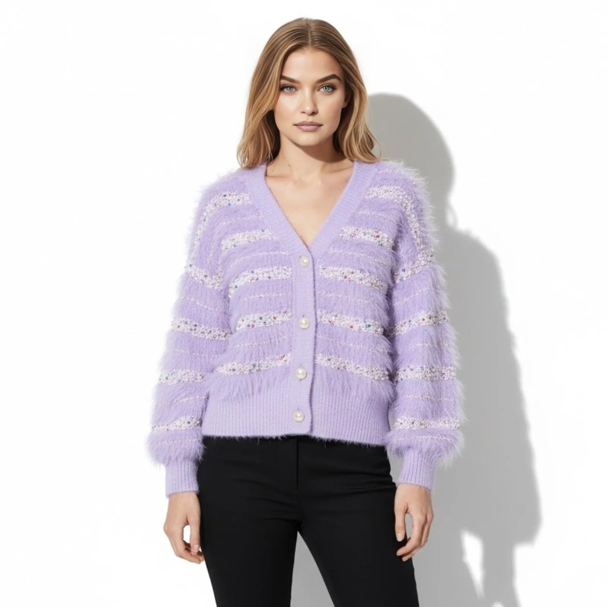 Model wearing the Kouvr purple fuzzy eyelash knit cardigan with pearl buttons, paired with black pants, front view.