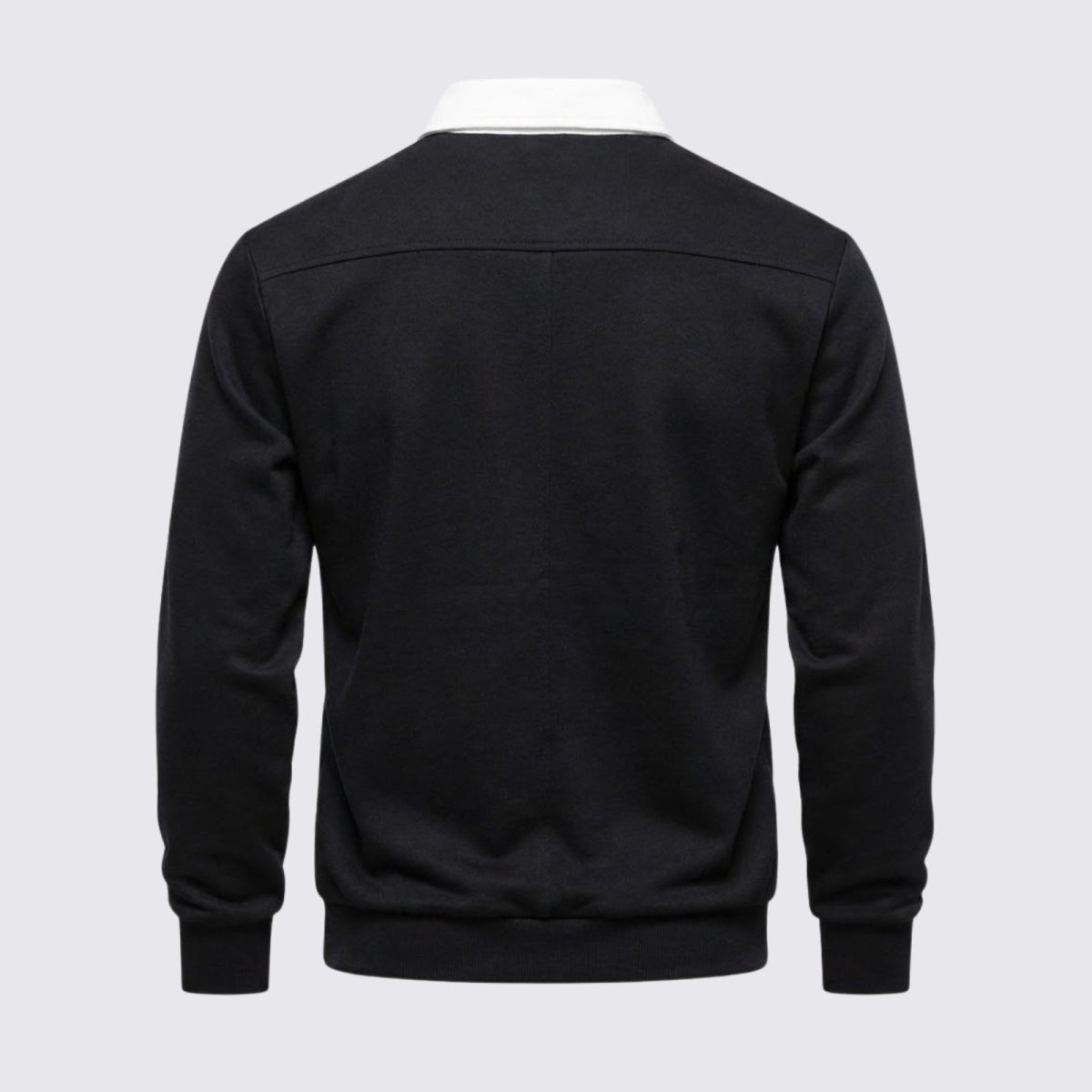 Flat product shot of the back of the Kouvr Rhodes black knit polo, highlighting the shoulder seam construction and shape.