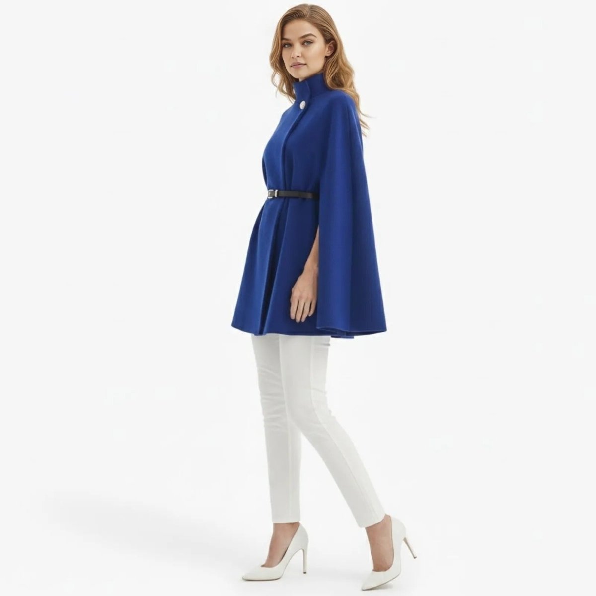  Side profile of a woman in the Kouvr royal blue high neck cape, highlighting the elegant drape and arm slit detail.
