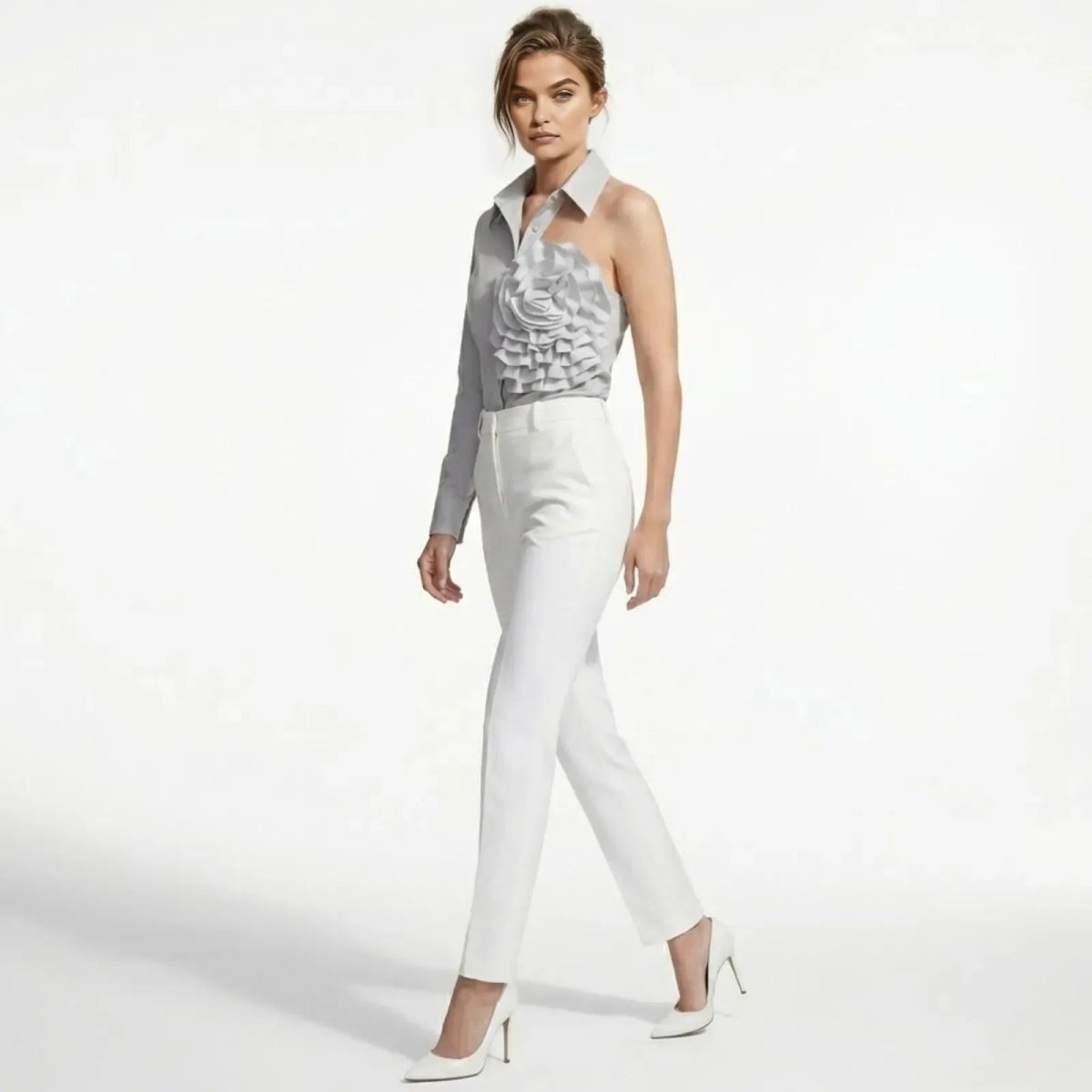 Side profile of a model walking in the Kouvr asymmetrical light grey collared blouse, showcasing its fit and silhouette.
