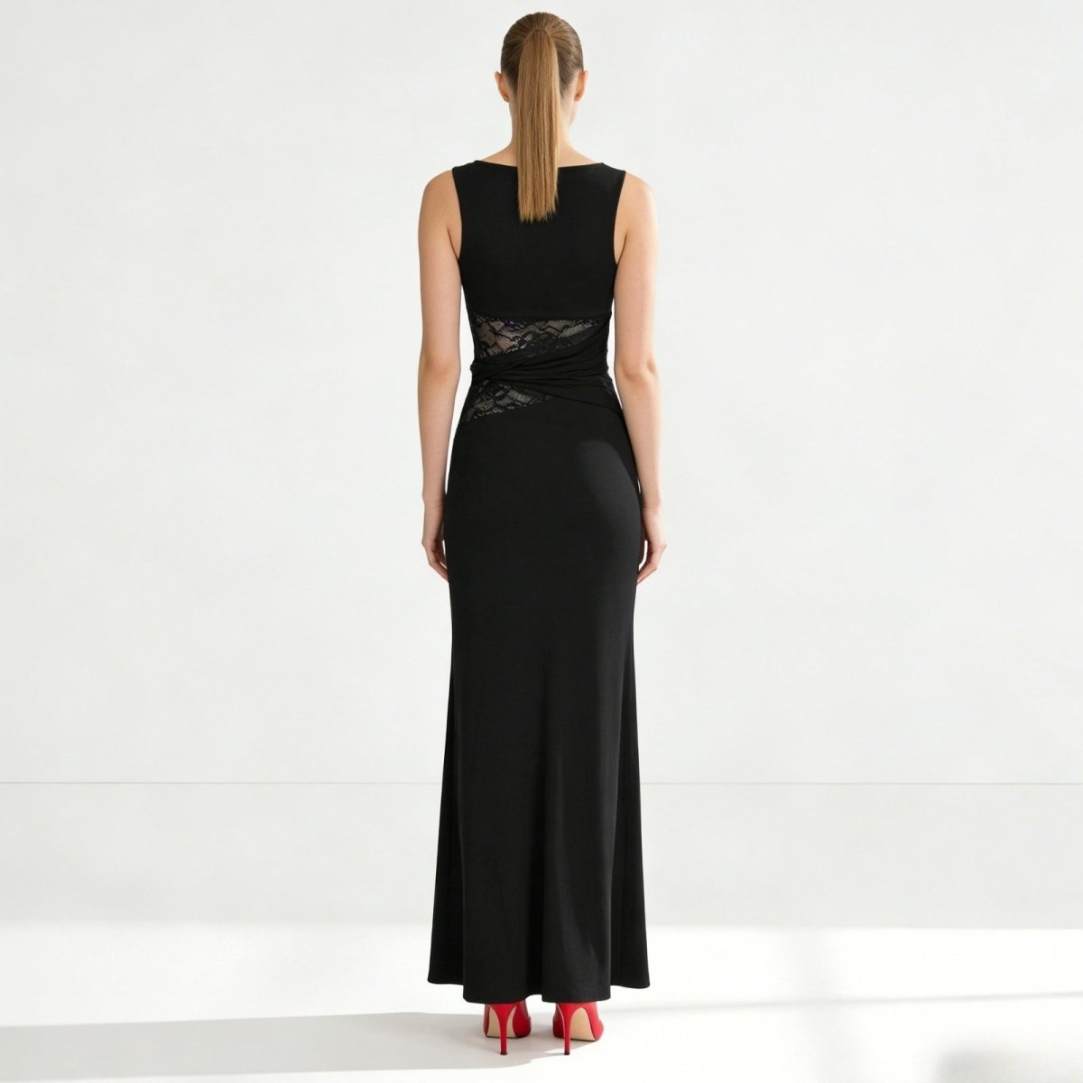 Back view of the Kouvr sleeveless black formal dress, showing the clean lines, high back, and concealed zipper detail.