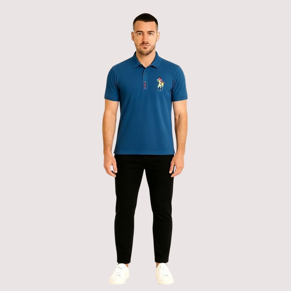 Man wearing a blue kouvr polo shirt with a logo on a light gray background