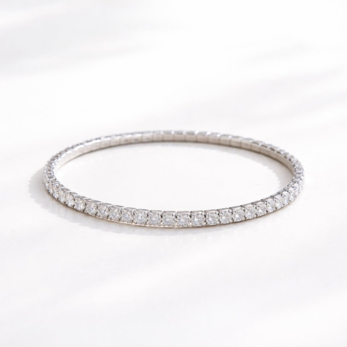Kouvr 3mm silver rhodium plated stretch tennis bracelet with AAAAA cubic zirconia on a bright white background.
