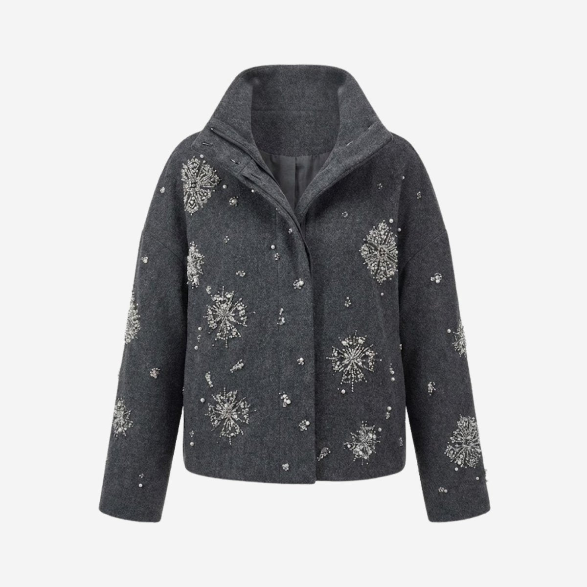 Flat product shot of the Kouvr dark grey wool funnel neck jacket, highlighting the detailed crystal and bead snowflake patterns on the front.
